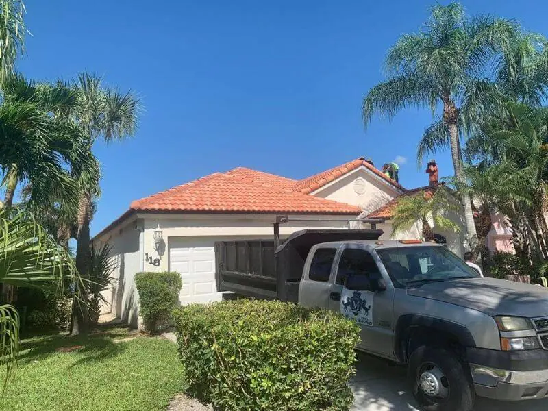 Terracotta barrel tile roof with the Mendieta crew truck in the driveway