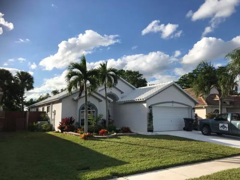 White tile roof on a large home with the Mendieta truck parked out front