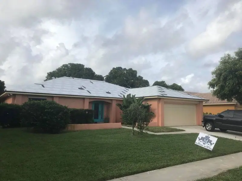 Single-story home dried in with white underlayment and the Mendieta Roofing yard sign on the lawn